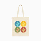 neutral color tote bag with 4 latte art tulips in a 2x2 grid: top left is blue, top right yellow, bottom left green, bottom right red. 