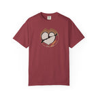 deep red t-shirt with a broken heart latte art print on its front side. Main colors: brown, gray, black (the arrow and part of the heart), orange.