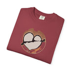 folded chili color (deep unsaturated red) t-shirt with a broken heart latte art print on its front side. Main colors: brown, gray, black (the arrow and part of the heart), orange.
