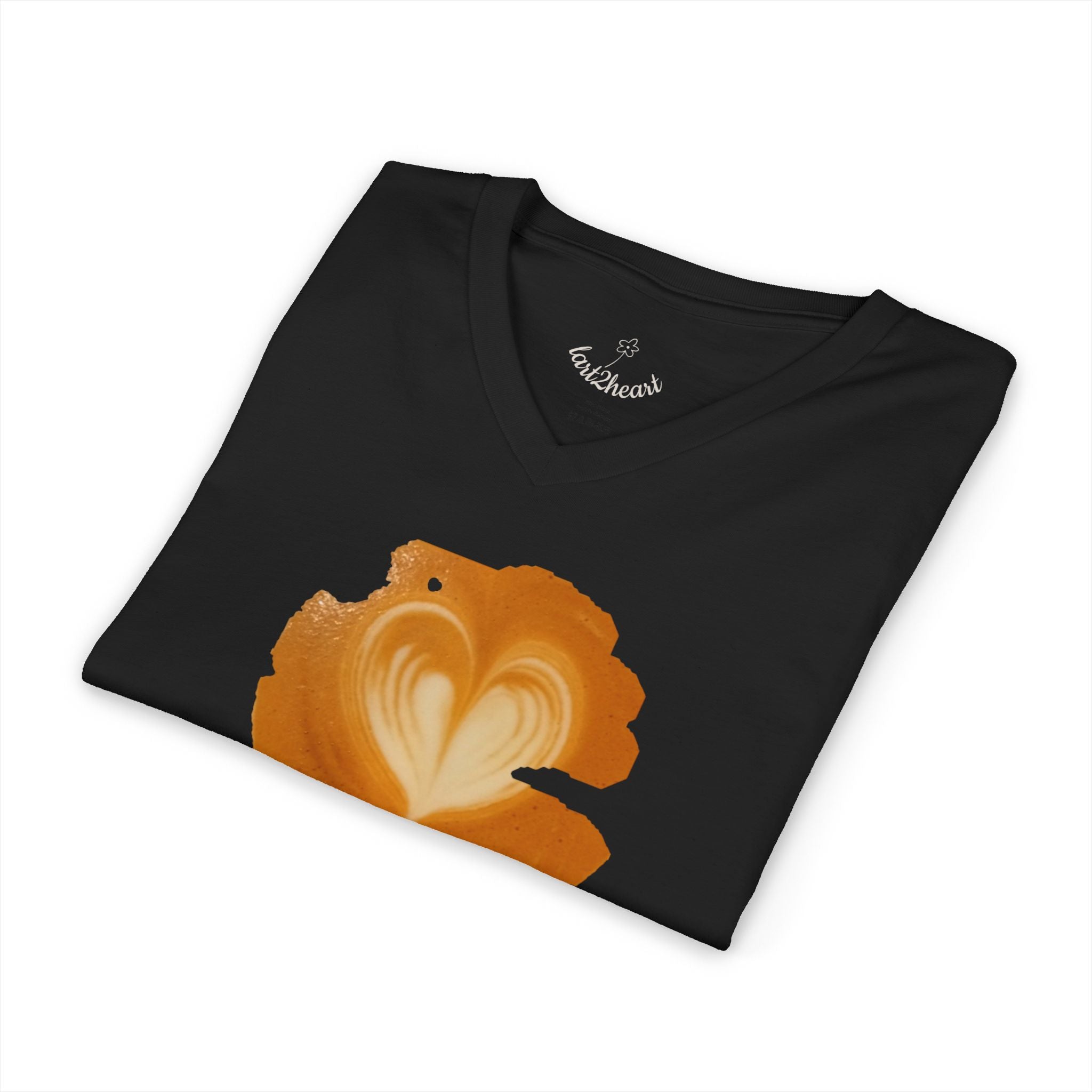 White v-neck t-shirt with a latte art print on its front side: a top view of latte art heart. Some parts of the brown foam look shredded. The shirt is folded, a branded neck label is visible