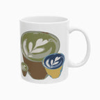 Latte art tulip in a small glass cup, on a white ceramic mug. The design includes 3 of that same pour in different sizes printed on each side of the mug. Main colors: green, blue, brown, mustard-yellow